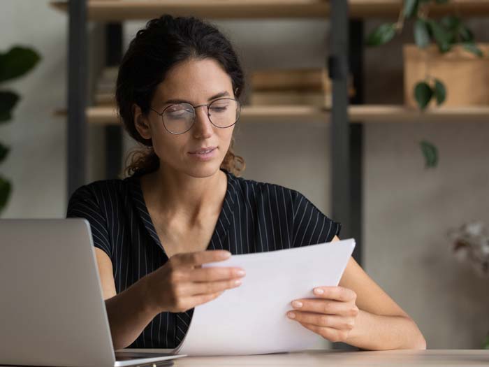 Lady checking over her CV. iStock.com/fizkes