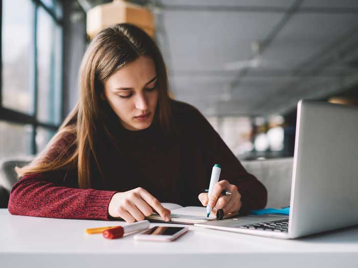 Student researching potential questions for job interview. Shutterstock.com/GalacticDreamer