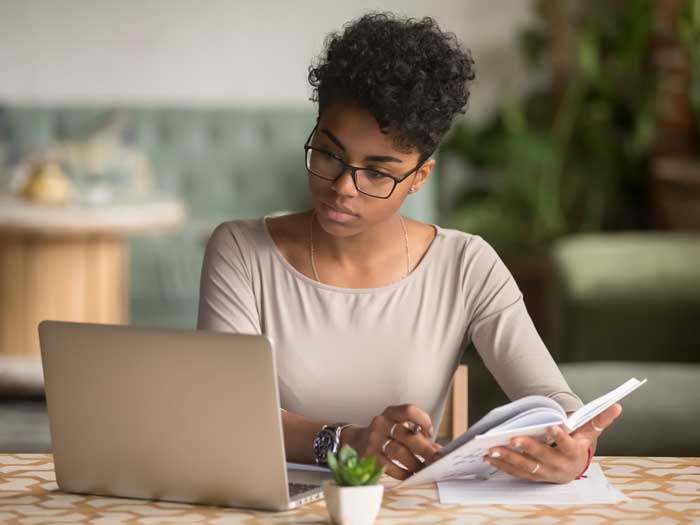 Woman preparing herself for a job interview. Shutterstock.com/fizkes