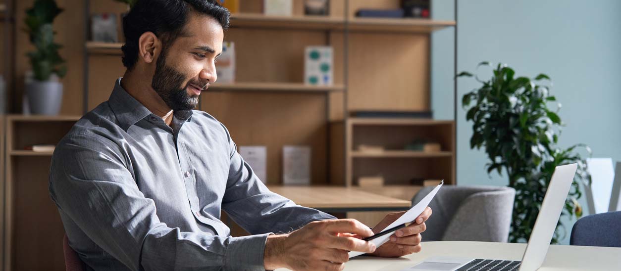 Man checking over his CV. iStock.com/insta_photos