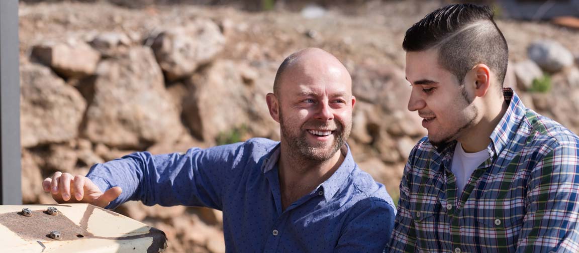 Farmer coaching young employee.