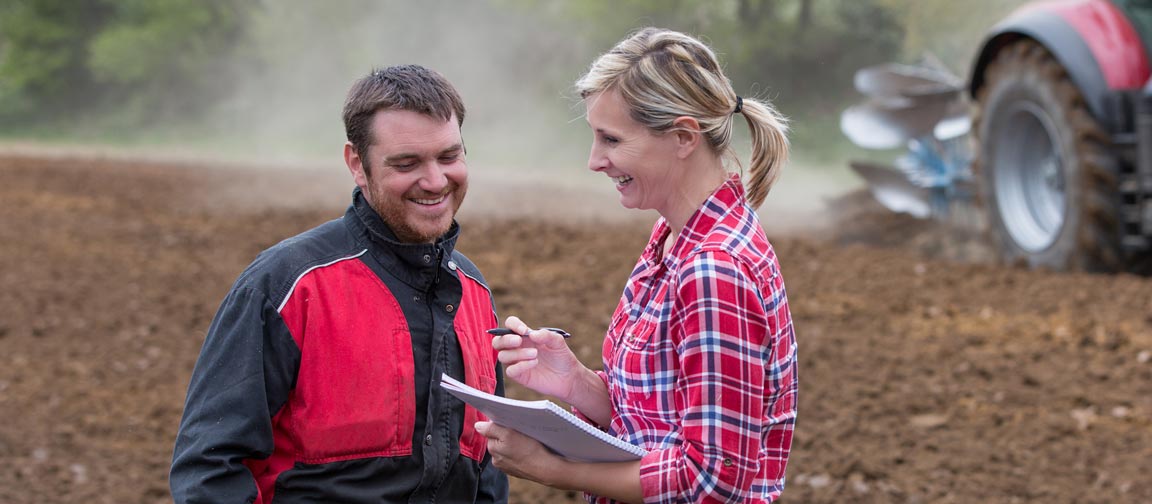 Farm worker finishing his appraisal with manager in the field. iStock.com/nicexray