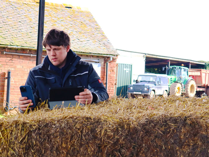 Farmer monitors his crop data on a tablet while reading the RB209 on his mobile.