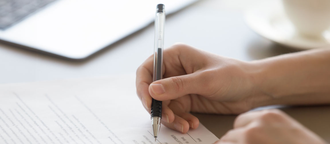 Large stack of paperwork being worked through with pen. Picture: fizkes/Shutterstock.com